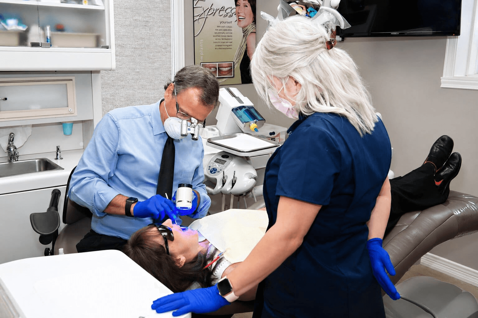 Dentist and assistant caring for a patient in a Cornwall Dental Arts operatory