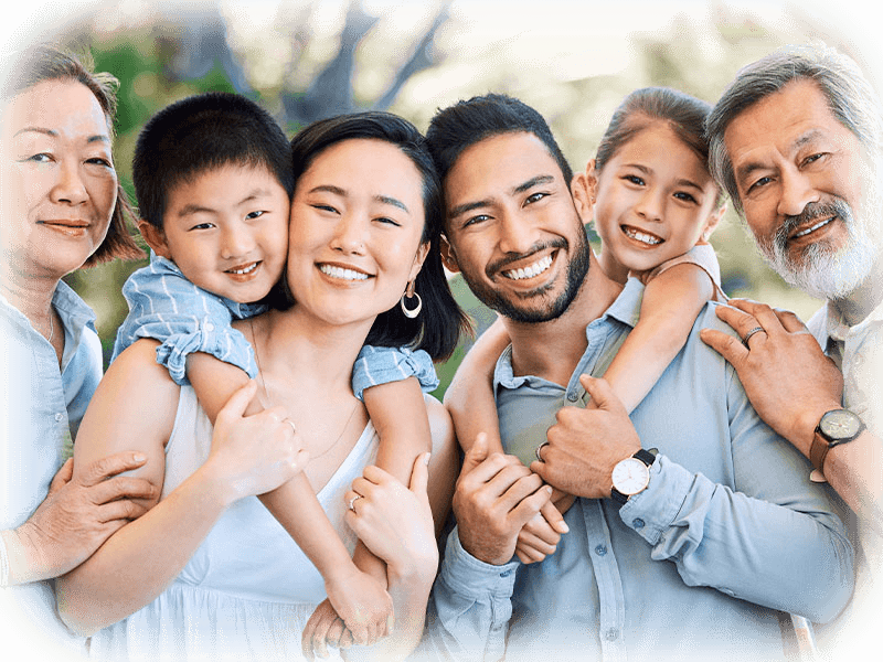 Happy family smiling together — clearer conversations supported by modern dental technology