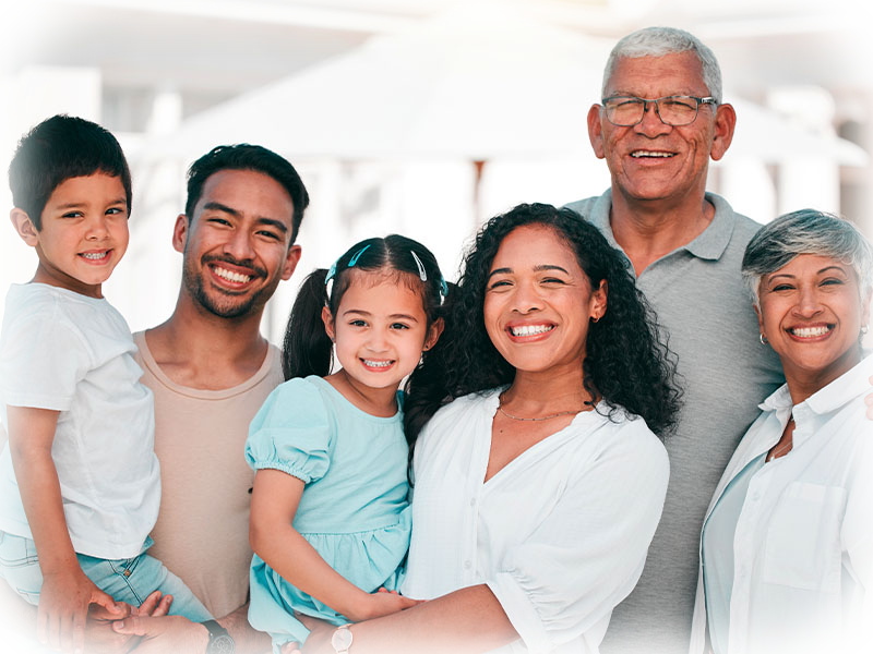 Multi-generational family smiling together outdoors